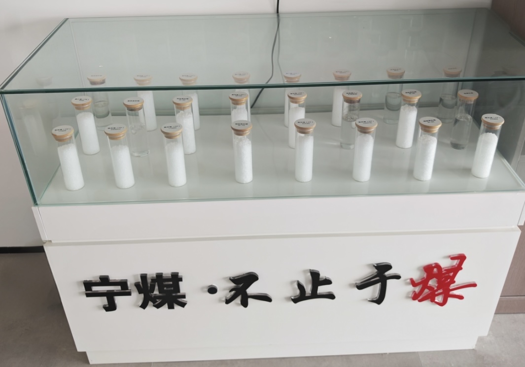 Glass display cabinet with various SNCC Ningmei coal-based PP PE plastic resin pellet samples